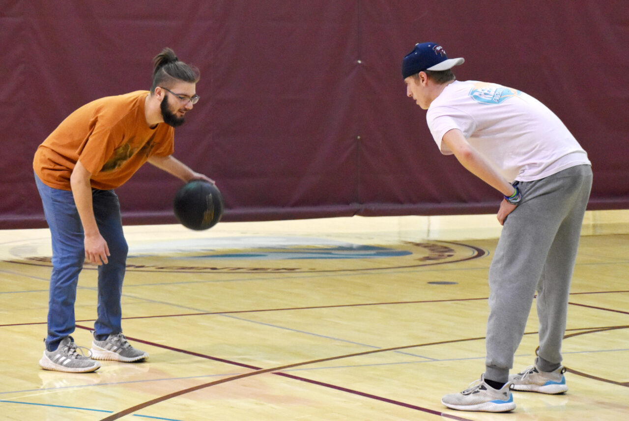 2 men playing basketball