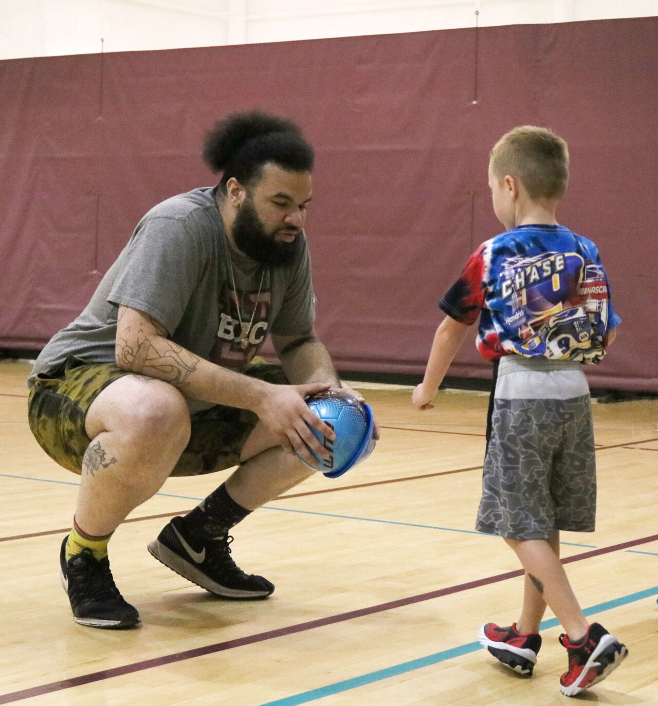 Ruben holding soccer ball with male student