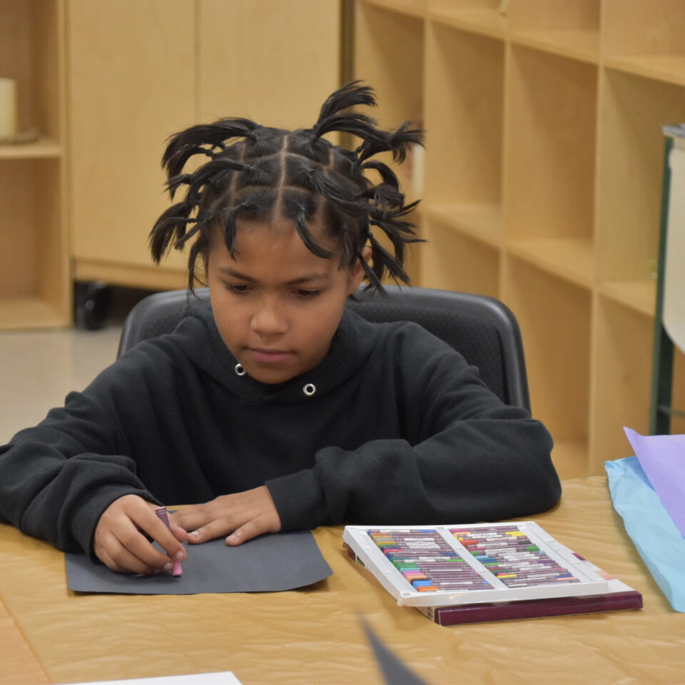 Kid doing art for Mind and Heart